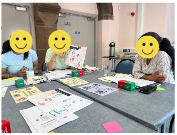 Support workers meeting with a family around a table